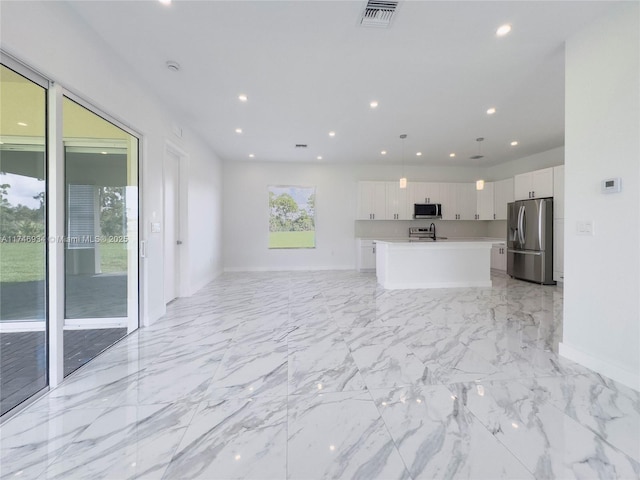 312 SE Via Sangro Prt, St Lucie, FL 34952 - unfurnished living room featuring recessed lighting and light marble finish floors