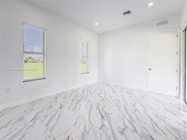 312 SE Via Sangro Prt, St Lucie, FL 34952 - empty room with recessed lighting and marble look tile flooring