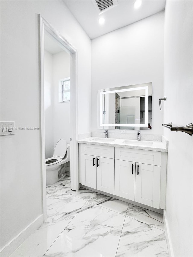 312 SE Via Sangro Prt, St Lucie, FL 34952 - bathroom with marble finish flooring, double vanity, and recessed lighting