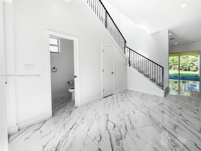 312 SE Via Sangro Prt, St Lucie, FL 34952 - unfurnished living room with stairway, marble look tiles, and recessed lighting