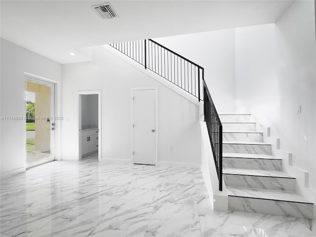 312 SE Via Sangro Prt, St Lucie, FL 34952 - staircase featuring marble finish floors and recessed lighting