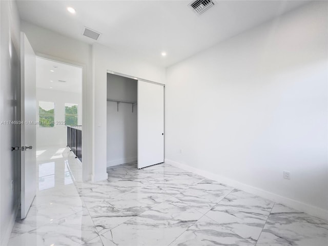 312 SE Via Sangro Prt, St Lucie, FL 34952 - unfurnished bedroom with recessed lighting, a closet, and light marble finish floors