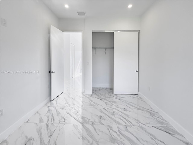 312 SE Via Sangro Prt, St Lucie, FL 34952 - unfurnished bedroom featuring a closet, light marble finish flooring, and recessed lighting