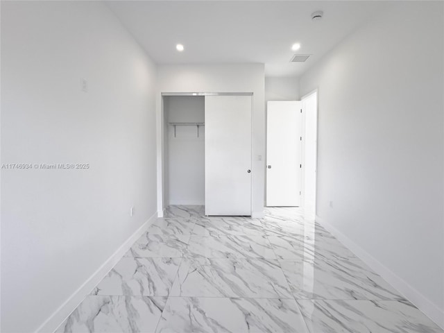 312 SE Via Sangro Prt, St Lucie, FL 34952 - unfurnished bedroom with light marble finish flooring, a closet, and recessed lighting