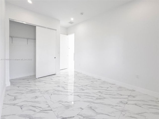 312 SE Via Sangro Prt, St Lucie, FL 34952 - unfurnished bedroom with a closet, recessed lighting, and light marble finish flooring