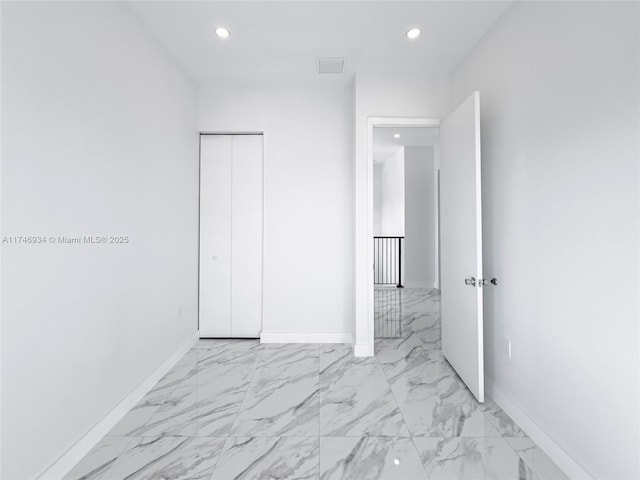 312 SE Via Sangro Prt, St Lucie, FL 34952 - unfurnished bedroom featuring recessed lighting, light marble finish floors, and a closet