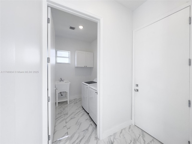 312 SE Via Sangro Prt, St Lucie, FL 34952 - laundry room featuring cabinet space, light marble finish floors, washer and dryer, and recessed lighting