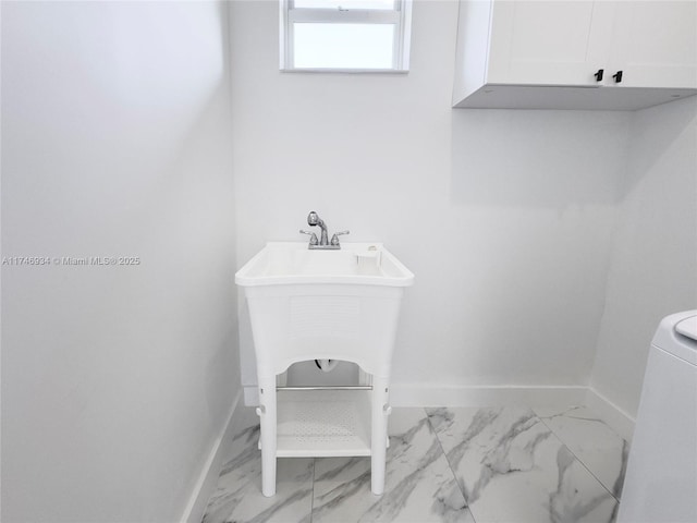 312 SE Via Sangro Prt, St Lucie, FL 34952 - bathroom with marble look tile flooring and washer / clothes dryer