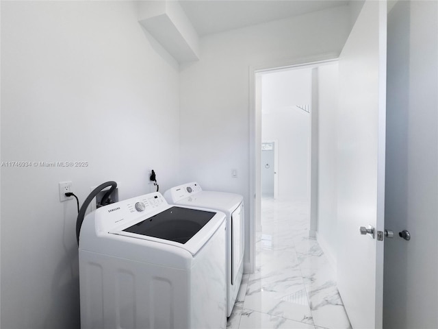 312 SE Via Sangro Prt, St Lucie, FL 34952 - laundry area with independent washer and dryer and light marble finish floors