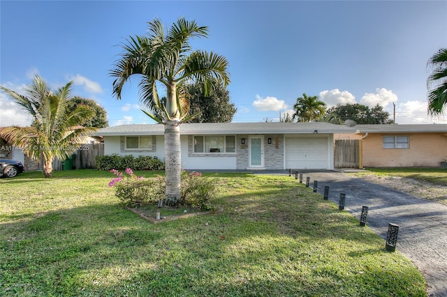 single story home featuring a garage and a front yard