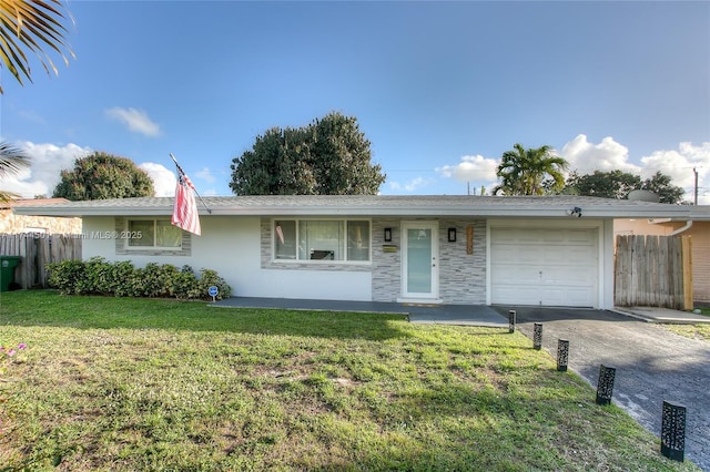 ranch-style home with a garage and a front yard