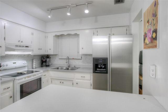 kitchen featuring sink, white cabinetry, stainless steel fridge with ice dispenser, electric stove, and decorative backsplash