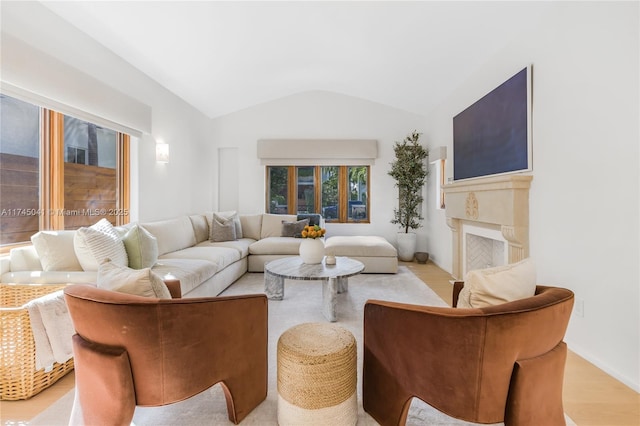 living room with vaulted ceiling and light hardwood / wood-style flooring