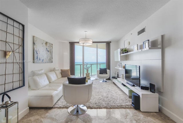 living room with a wall of windows and a textured ceiling