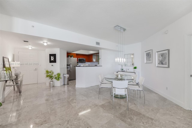 unfurnished dining area with a textured ceiling and an inviting chandelier