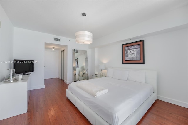 bedroom with hardwood / wood-style flooring