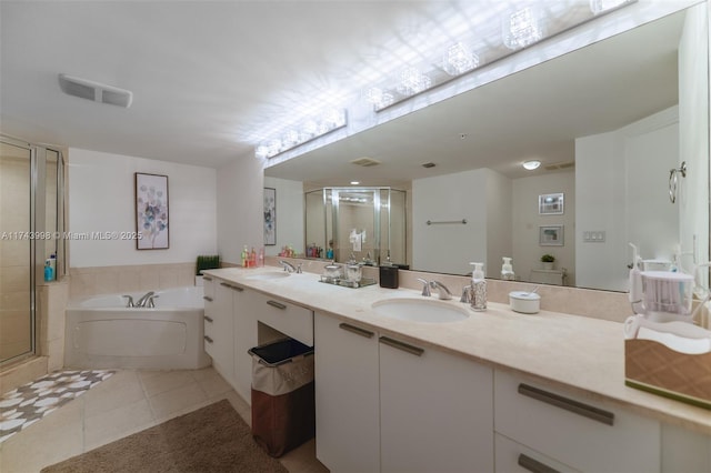 bathroom featuring vanity, shower with separate bathtub, and tile patterned floors