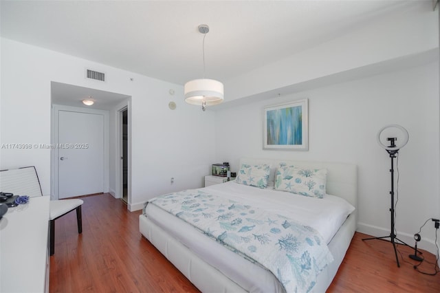 bedroom with hardwood / wood-style flooring