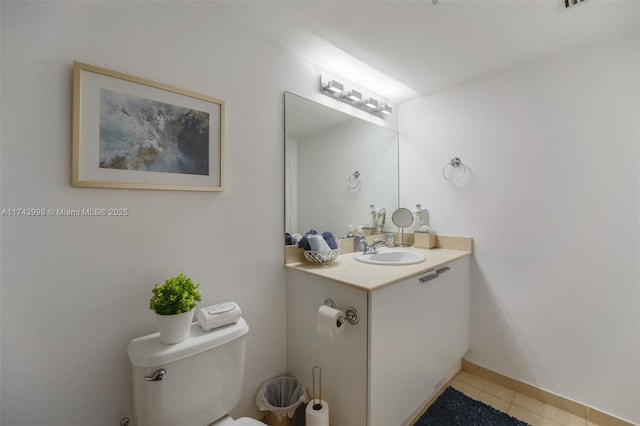 bathroom featuring tile patterned floors, toilet, and vanity