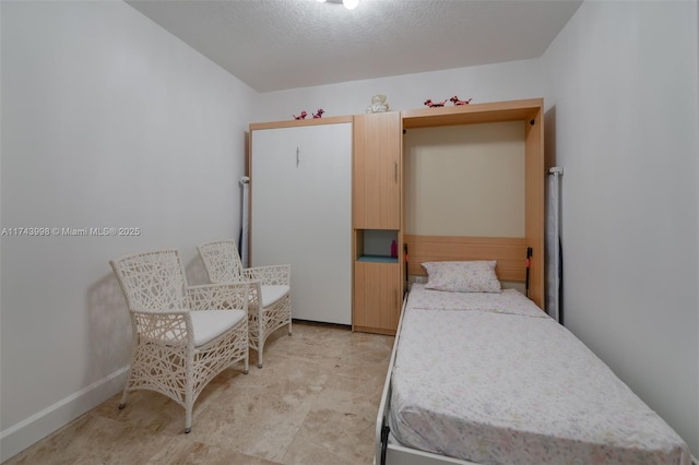 bedroom featuring a textured ceiling