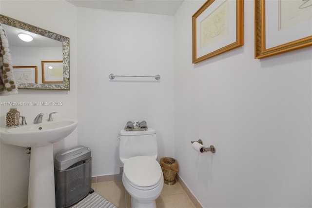 bathroom featuring tile patterned floors, sink, and toilet