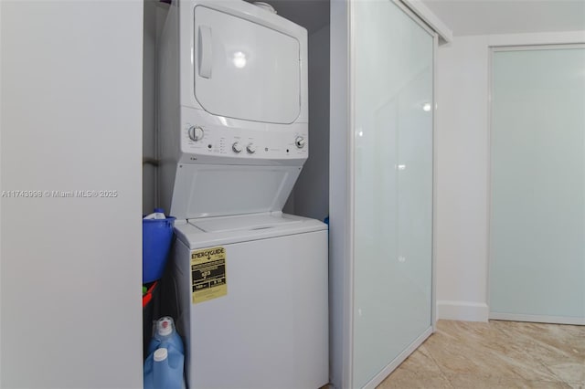 laundry area featuring stacked washer / drying machine