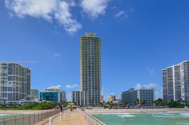 exterior space with a water view and a beach view