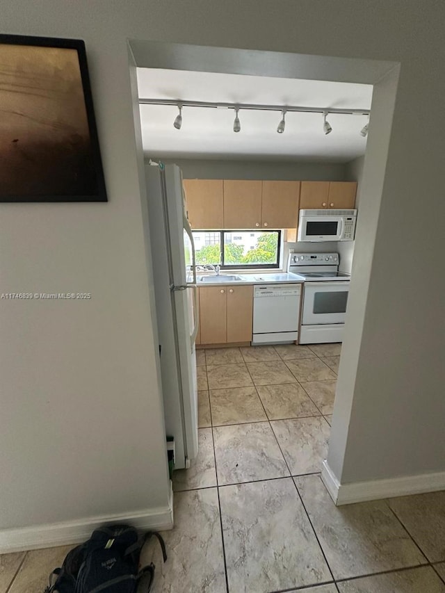 17011 N Bay Rd Unit 507, Sunny Isles Beach, FL 33160 - kitchen with white appliances, track lighting, light brown cabinetry, and light countertops