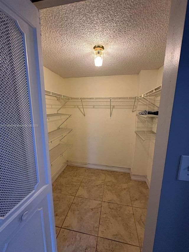 17011 N Bay Rd Unit 507, Sunny Isles Beach, FL 33160 - walk in closet featuring light tile patterned floors