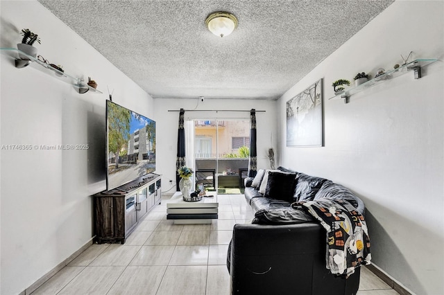 living room with a textured ceiling and light tile patterned flooring