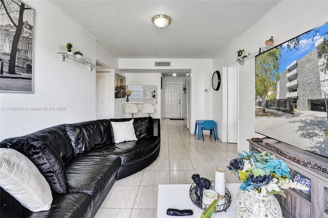 living room featuring light tile patterned floors and a textured ceiling