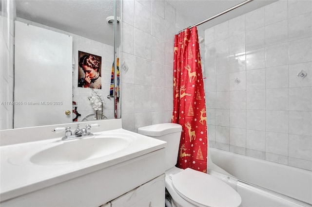 full bathroom with tile walls, vanity, a textured ceiling, shower / bathtub combination with curtain, and toilet