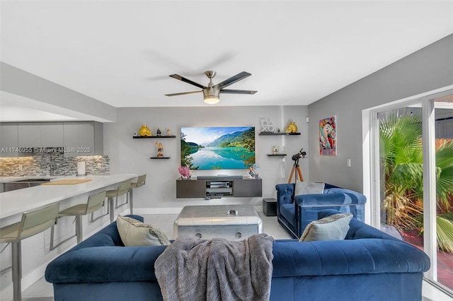 living room featuring sink and ceiling fan