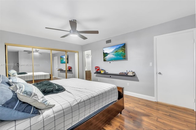 bedroom featuring hardwood / wood-style flooring, ceiling fan, and a closet