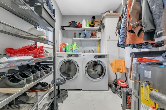 laundry room with electric water heater and separate washer and dryer