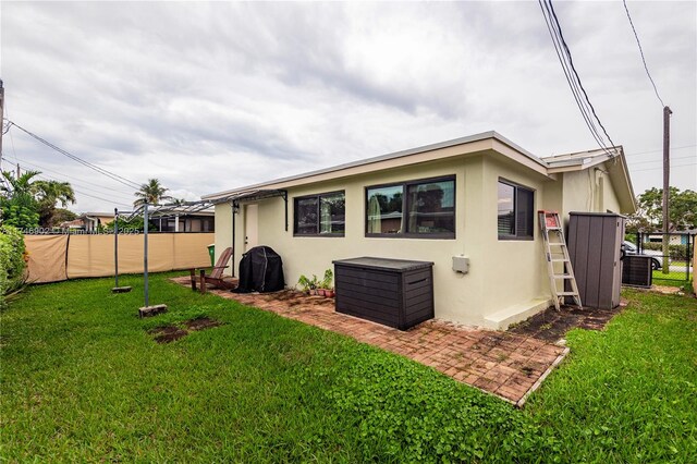 2713 NW 53rd St, Tamarac, FL 33309 - back of house featuring a patio, stucco siding, fence, and a lawn