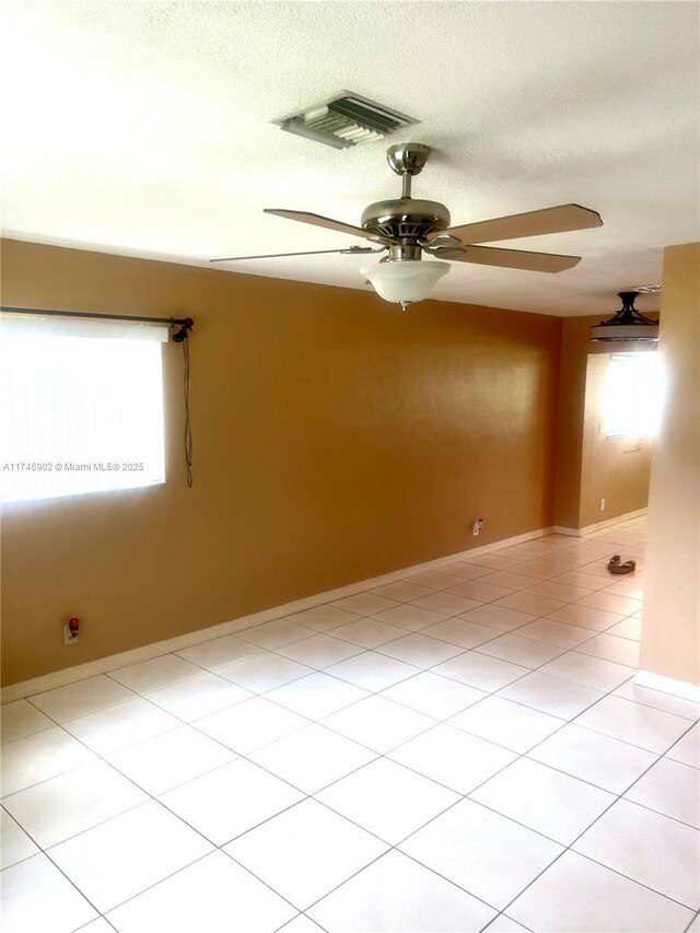 2713 NW 53rd St, Tamarac, FL 33309 - spare room with a textured ceiling, visible vents, ceiling fan, and light tile patterned floors