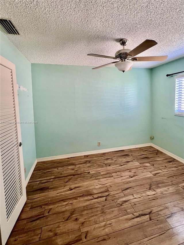 2713 NW 53rd St, Tamarac, FL 33309 - empty room featuring a textured ceiling, wood finished floors, visible vents, and a ceiling fan