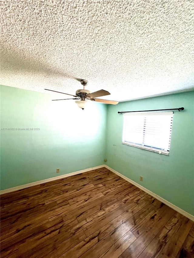 2713 NW 53rd St, Tamarac, FL 33309 - spare room with wood finished floors, a textured ceiling, a ceiling fan, and baseboards