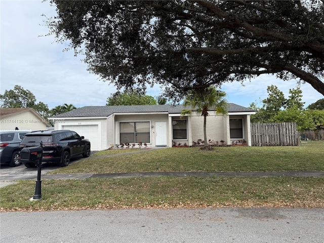 single story home featuring a garage and a front lawn