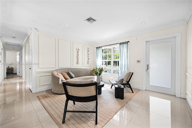 living room featuring light tile patterned floors, ornamental molding, visible vents, and a decorative wall