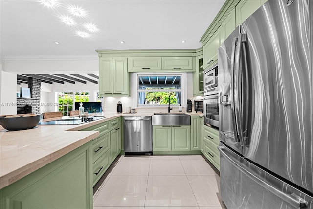 kitchen featuring light tile patterned floors, appliances with stainless steel finishes, light countertops, and green cabinetry