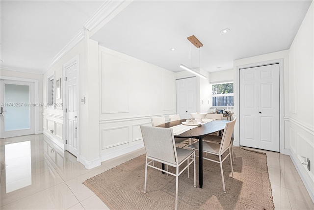 dining space with light tile patterned floors, ornamental molding, recessed lighting, and a decorative wall