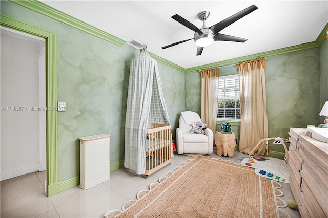 unfurnished bedroom featuring light tile patterned floors, baseboards, visible vents, ceiling fan, and ornamental molding