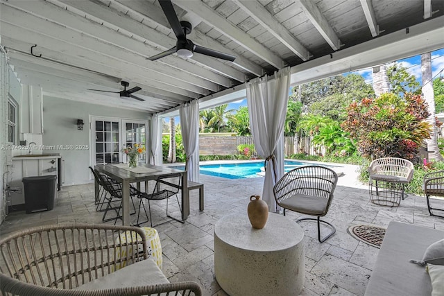 view of patio featuring outdoor dining space, a fenced backyard, a ceiling fan, and a fenced in pool