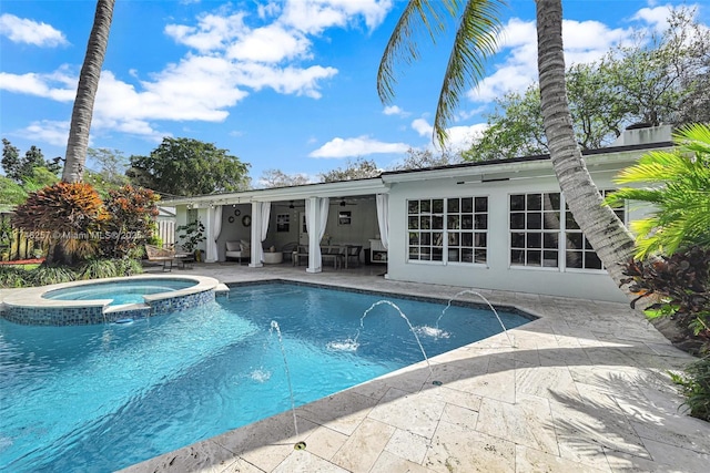 view of pool featuring a patio area, a pool with connected hot tub, and a ceiling fan