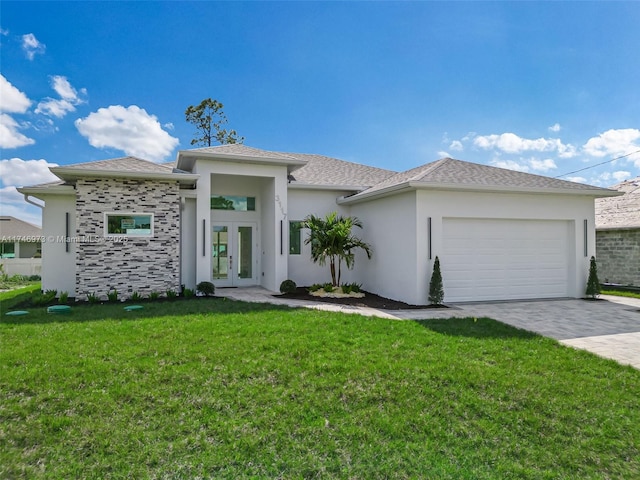 view of front of house featuring a garage, a front lawn, and french doors