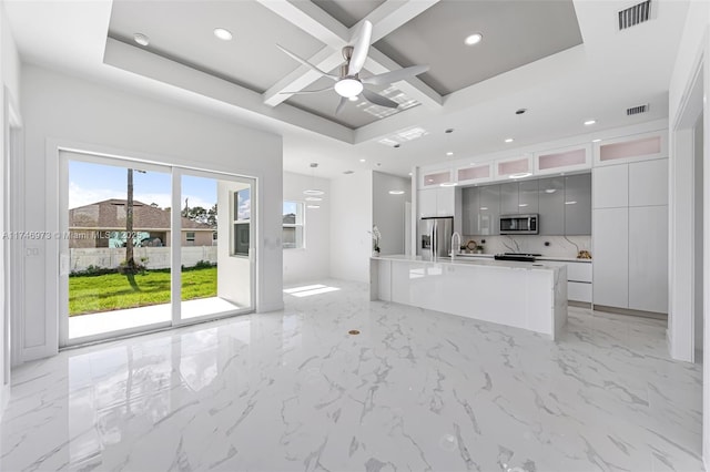 kitchen with gray cabinets, appliances with stainless steel finishes, pendant lighting, an island with sink, and coffered ceiling