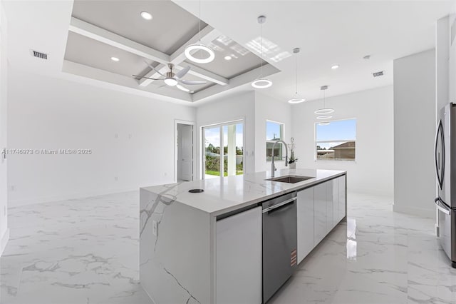 kitchen featuring white cabinetry, an island with sink, sink, hanging light fixtures, and coffered ceiling