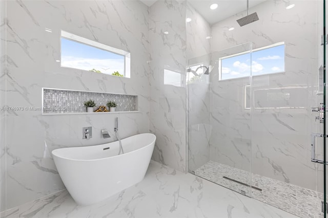 bathroom featuring plenty of natural light and plus walk in shower